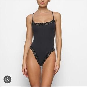 Black Lace Trim Bodysuit skims